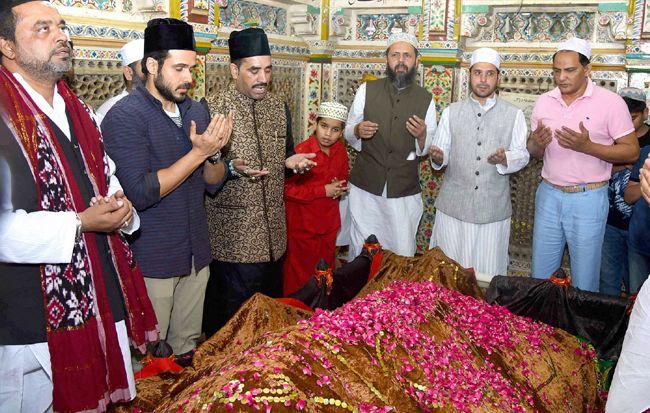 Spiritual counselor guiding a couple with Islamic patterns background